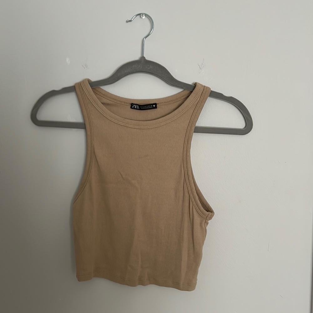 Tan, cropped top that hugged collarbone, from Zara. Size large.